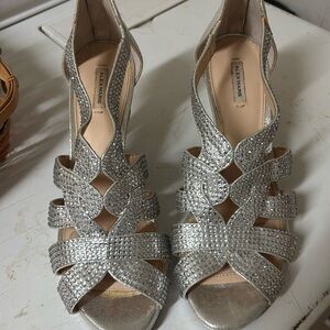 Alex Marie Shimmering Silver Strappy Heels
Wore once.  Cushioned sole.